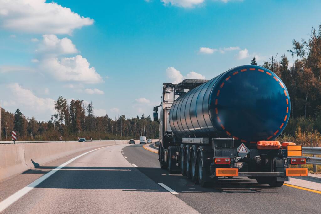 Fuel tanker truck on the highway asphalt road on fall autumn day